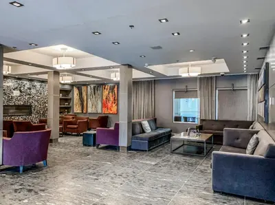 a hotel lobby with couches and tables and chairs at Cozy King Condo Mountain Views, Resort Perk and BBQ in Canmore