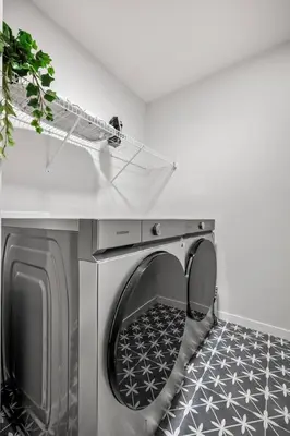 a washing machine with its door open in a room at Luxury 7 Bedroom House with Karaoke Sound System and 100 Inch Projector in Calgary