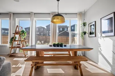 a dining room with a table and a bench at Luxury 7 Bedroom House with Karaoke Sound System and 100 Inch Projector in Calgary