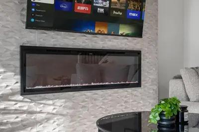 a flat screen tv hanging on a wall at Luxury 7 Bedroom House with Karaoke Sound System and 100 Inch Projector in Calgary