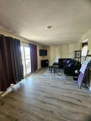 a living room with a couch and a table at The Onyx Suite In Inglewood Minutes To DT in Calgary