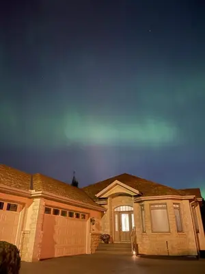 a house with two garage doors and a sky at Peaceful & Cozy Retreat by the Park in Calgary