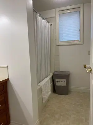 a bathroom with a shower and a window at Peaceful & Cozy Retreat by the Park in Calgary