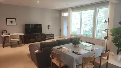 a living room with a couch and a table at Peaceful & Cozy Retreat by the Park in Calgary