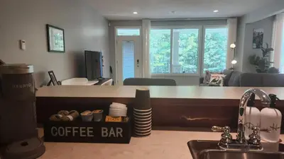 a kitchen with a counter with a coffee bar at Peaceful & Cozy Retreat by the Park in Calgary