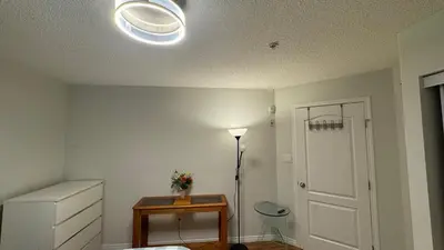 a room with a white ceiling with a light and a door at Main Floor Condo Fully Independent 1 Bed 1 Bath in Edmonton