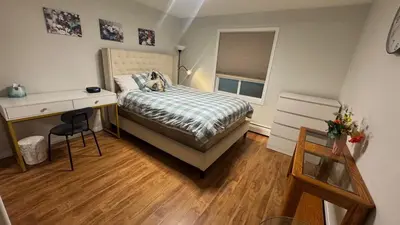 a bedroom with a bed and a desk and a desk at Main Floor Condo Fully Independent 1 Bed 1 Bath in Edmonton
