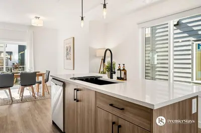 a kitchen with a sink and a counter top at Luxurious Designer Finished Home in Calgary