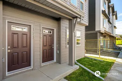 a house with two brown doors on the side of it at Luxurious Designer Finished Home in Calgary