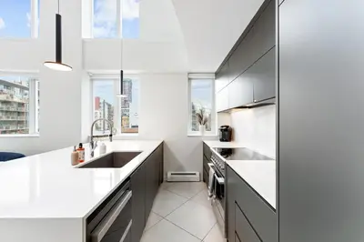 a kitchen with white countertops and gray cabinets at The Vancouver Penthouse, 2-Level, Patios, Hot Tub in Vancouver