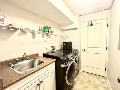 a kitchen with a sink and a washing machine at Bella Sweet Suite -Cozy 2B suite Morgan Creek in Surrey