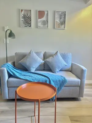 a living room with a couch and a table at Bella Sweet Suite -Cozy 2B suite Morgan Creek in Surrey