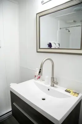 a bathroom with a sink and a mirror at Westview Centre Motel Ltd in Powell River
