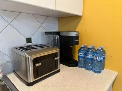 a counter with bottles of water sitting next to a blender at UBC Two-Bedroom Suite - Steps from Beach, Park & Golf - Full Kitchen in Vancouver