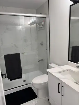 a bathroom with a shower and a toilet and a sink at Cozy Private Suite in Langley in Langley
