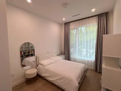 a white bedroom with a bed and a mirror at New Lux House on Vancouver West in Vancouver