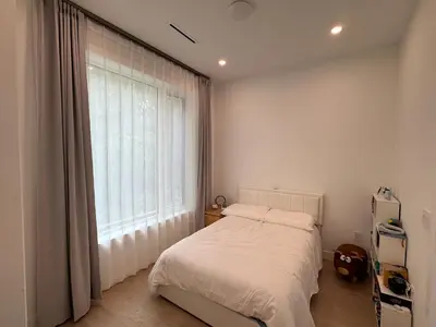 a bedroom with a bed and a large window at New Lux House on Vancouver West in Vancouver