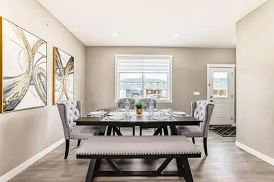 a dining room with a table and chairs at Cozyhub Vacation Rental Calgary-3Bedroom with AC in Calgary