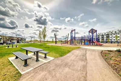 a park with a playground with benches and a slide at Cozyhub Vacation Rental Calgary-3Bedroom with AC in Calgary