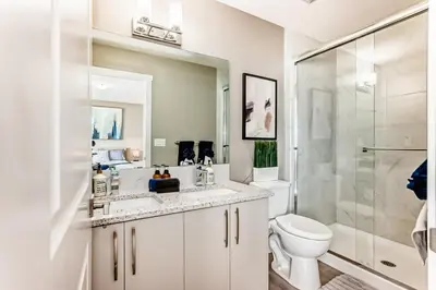 a bathroom with a sink and a toilet and a shower at Cozyhub Vacation Rental Calgary-3Bedroom with AC in Calgary