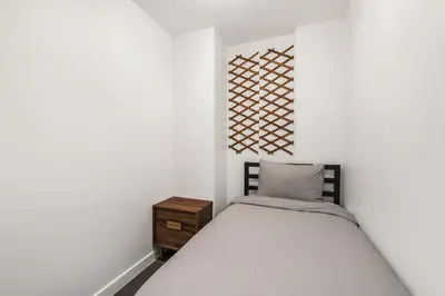 a small bedroom with a bed and a nightstand at Modern Condo in Downtown Vancouver in Vancouver
