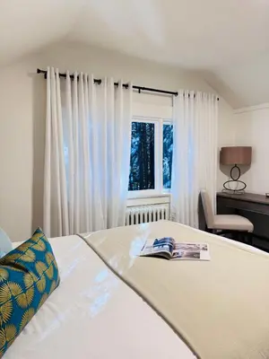 a bedroom with a bed with a book on it at Modern Queen Room Ensuite Bathroom Vancouver West in Vancouver