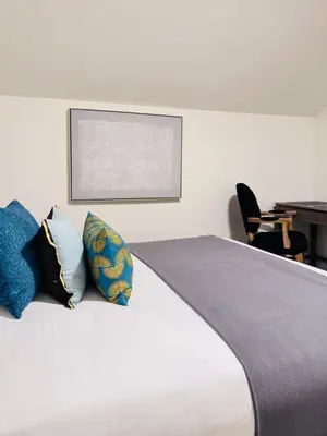 a bedroom with a bed with pillows on it at Modern Queen Room Ensuite Bathroom Vancouver West in Vancouver