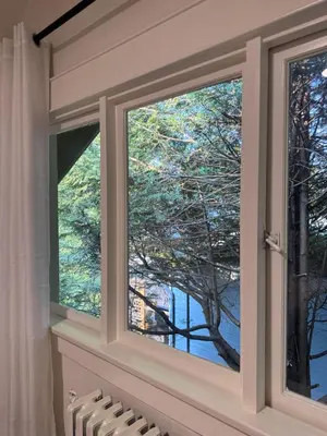 a window with a view of a tree at Modern Queen Room Ensuite Bathroom Vancouver West in Vancouver