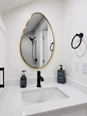 a bathroom with a white sink and a mirror at Modern Queen Room Ensuite Bathroom Vancouver West in Vancouver