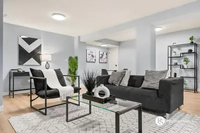a living room with a couch and a table at Spacious Cozy Couples Getaway Basement Suite in Sundance in Calgary