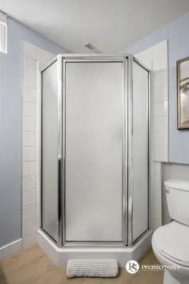 a bathroom with a glass shower with a toilet at Spacious Cozy Couples Getaway Basement Suite in Sundance in Calgary