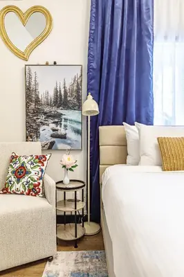 a bedroom with a bed and a couch and a chair at Westwinds - Funky Basecamp in the Rockies in Canmore
