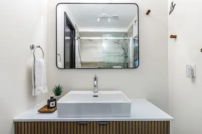 a bathroom with a white sink and a mirror at Westwinds - Funky Basecamp in the Rockies in Canmore