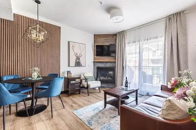 a living room with a couch and a table at Westwinds - Funky Basecamp in the Rockies in Canmore