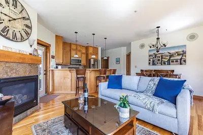a living room with a couch and a fireplace at McAuley Manor - Mountain Views Downtown Location in Canmore