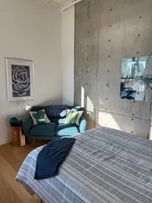 a bedroom with a bed and a couch at Downtown Studio Rental in Victoria