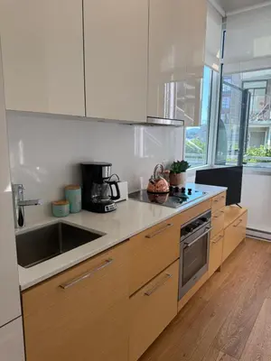 a kitchen with a sink and a counter top at Downtown Studio Rental in Victoria
