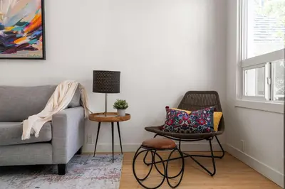 a living room with a couch and a chair at The Lokal 2 Kings Queen Suite in Sunnyside YYC in Calgary