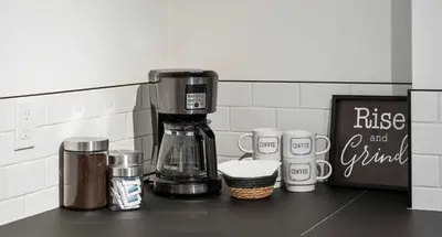 a coffee maker sitting on top of a counter at The Sunday Charming Private Suite in Calgary in Calgary