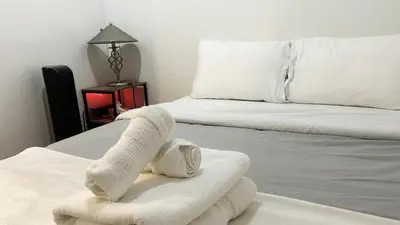 a room with two beds with towels on them at Urban Calm, Comfort in the Heart of the City in Vancouver