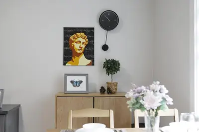a dining room with a table and a clock on the wall at Cozy 2BR for Family & Private Parking & Near Mall in Langley