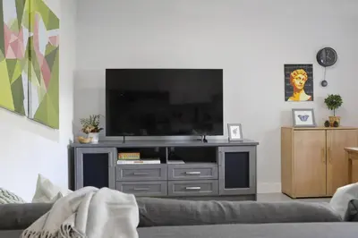 a living room with a flat screen tv at Cozy 2BR for Family & Private Parking & Near Mall in Langley