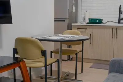 a kitchen with a table and two chairs and a counter at Modern Suite by Hospital 2 Near Transit, Wi-Fi, Netflix in Edmonton