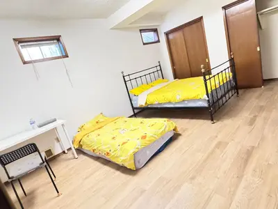 two beds with yellow sheets in a room at Only 7 km from YYC Sandstone Homestay in Calgary