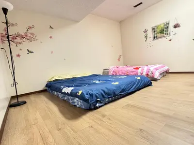 a room with two beds and a lamp in it at Only 7 km from YYC Sandstone Homestay in Calgary