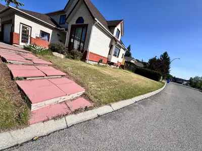 a house with red bricks on the side of the road at Only 7 km from YYC Sandstone Homestay in Calgary