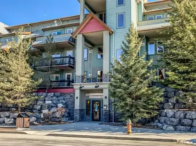 a building with a fire hydrant in front of it at Lodges at Canmore Resort in Canmore