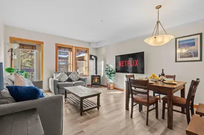 a living room with a table and a dining room at Lodges at Canmore Resort in Canmore