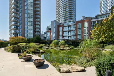 a garden in a city with tall buildings at Central City Location, Bay View, One Free Parking in Vancouver