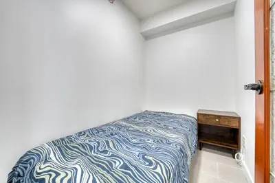 a bedroom with a bed and a dresser in a room at Central City Location, Bay View, One Free Parking in Vancouver
